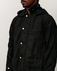 Lightweight field parka, unisex long-sleeve coat in black with snap placket and hood.