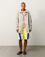 Lightweight unisex long coat with long sleeves in Stone.