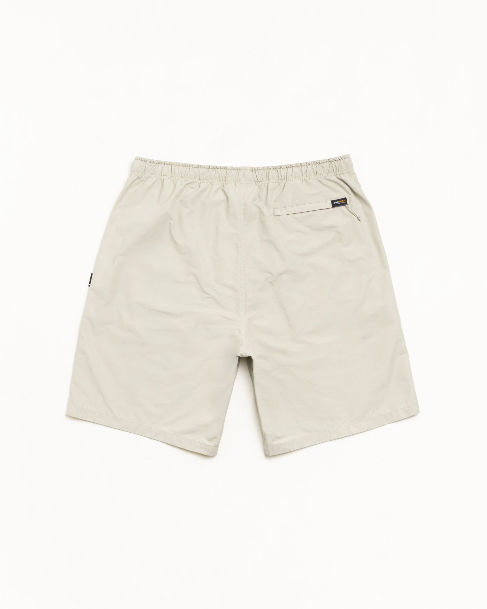 Transit Short unisex shorts in Sand with elastic waist and rear zip pocket, nylon-cotton blend.
