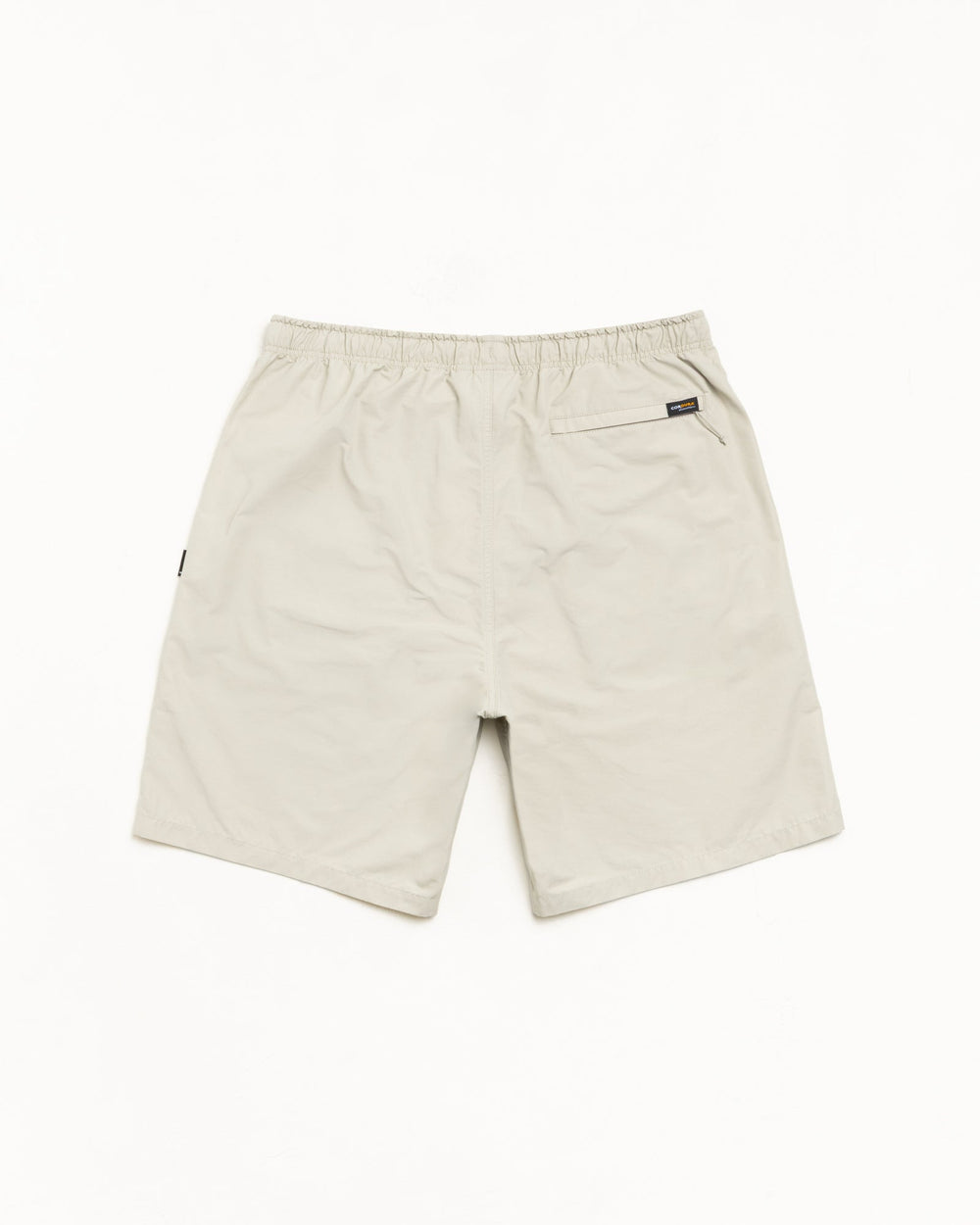 Transit Short unisex shorts in Sand with elastic waist and rear zip pocket, nylon-cotton blend.